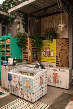 there are many different types of food on display in this store front window, including pizza boxes and coolers