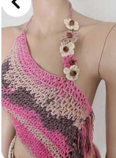 a crocheted halter top with flowers on the front and bottom, attached to a mannequin