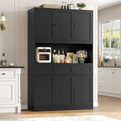 a kitchen with black cabinets and white appliances