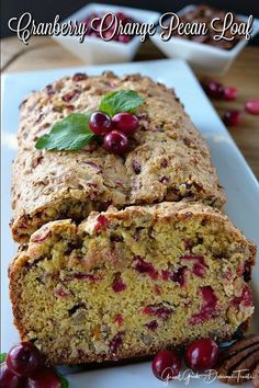 a loaf of cranberry orange pecan loaf on a plate