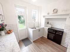 a kitchen with an oven, dishwasher, sink and stove top in it