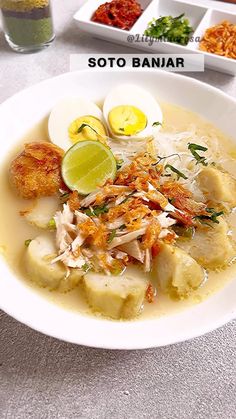 a white bowl filled with food on top of a table