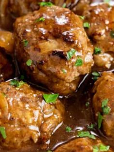 meatballs with gravy and parsley in a bowl