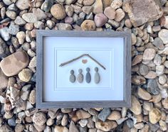 rocks and pebbles arranged in a frame on the ground