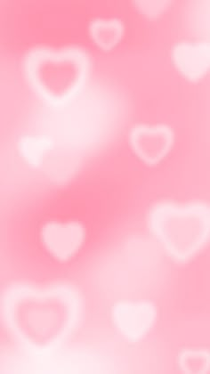 a blurry background with hearts in pink and white