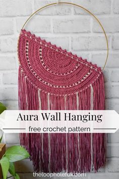 a crocheted wall hanging with the text, aura wall hanging free crochet pattern