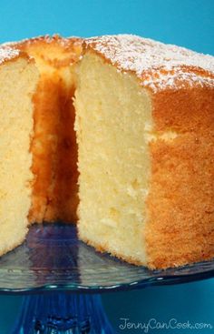 a cake that has been cut in half and is on a blue plate with one slice taken out