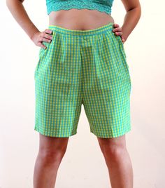 This is a super cute pair of 60s vintage mod checkered shorts! They're blue and yellow checked cotton, which appears mostly green overall when viewed from a distance. They are a Bermuda shape with a high waist, a 0.75" wide waistband and two sliding tabs at the back sides that adjust with four buttons. They do not have pockets, they are shaped with front and back darts, and they close with a 7" long yellow nylon side zipper and a pearl button on your left side. They are in good clean condition overall with a 1.25" hand stitched repair on the center horizontal crotch seam, please see the close up photo of this repair. No other wear, flaws or issues noted. The label says "S.S. Kresge Co., Quality Guaranteed, 100% Cotton, Wash 'N Wear, 18, Made in Japan." The S.S. Kresge stores became K-Mart Gingham Cotton High-waisted Shorts, High-waisted Gingham Cotton Shorts, Plaid Short Summer Bottoms, Summer Plaid Short Length Bottoms, Plaid Short Length Summer Bottoms, Cotton Bottoms For Picnic, Short Length, Cotton Shorts For Picnic, Cotton Bottoms For Picnic In Short Length, Retro Summer Shorts