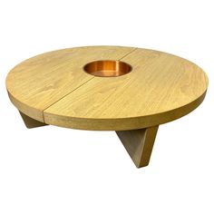 a round wooden table with a hole in the center