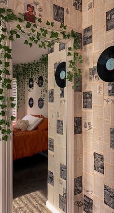 there is a room with records on the wall and plants growing out of the walls