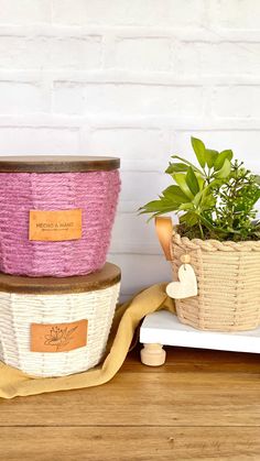 three baskets with plants in them sitting on a table