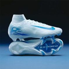 a pair of white and blue soccer cleats