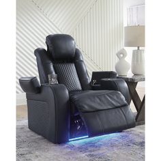 a black recliner chair with blue lights on the armrests and foot rest