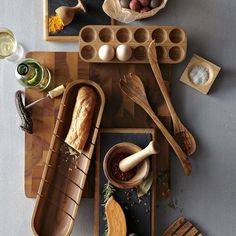 an overhead view of food and utensils on a cutting board, including bread