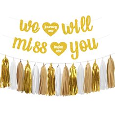 a banner that says we love you with tassels and gold foil lettering on it