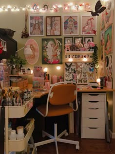 a room with many pictures and lights on the wall, including an office chair in front of a desk