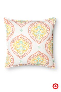 an orange, yellow and green pillow on a white background with the word love written in red