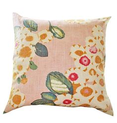 an orange and pink pillow with flowers on it