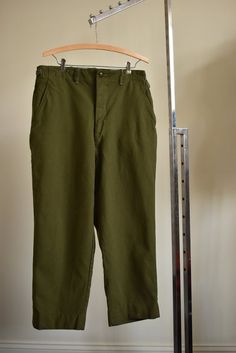 EXCELLENT condition 1950s US military issued M-1951 olive green wool trouser. Issued in 1953. NO flaws to note. Zipper is Rapid, details are stamped permanently into waistband and back inside pocket. Two back pockets button closed, two side pockets, & one small interior button-closable pocket pouch. Side cinches, inside buttons for suspenders. Belt loops also. Inside seams are serged. Marked Medium Short. 83% wool 17% nylon. MEASUREMENTS ARE TAKEN LYING FLAT UNLESS NOTED. DOUBLE CHEST, WAIST Military Style Work Pants With Tapered Leg, Military Style Tapered Leg Work Pants, Vintage Khaki Work Pants, Vintage Khaki Cargo Pants For Work, Vintage Green Cotton Work Pants, Vintage Green Cargo Pants, Sack Dress, Angel Sleeve, Kick Flares