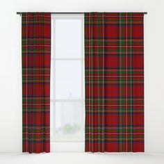 a red and green plaid curtain hanging in front of a window with a white wall