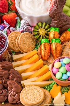 an assortment of cookies, crackers, candy and candies on a platter