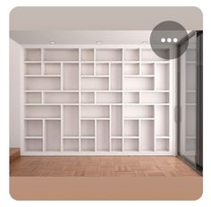 an empty room with white bookcases on the wall and wood flooring in front of it