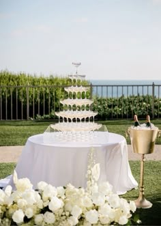 a wedding cake sitting on top of a table next to a vase filled with flowers