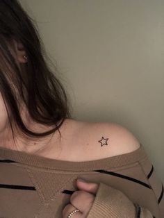 a woman with a small star tattoo on her left upper arm and right lower arm