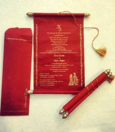 a red menu with gold trim and tassels sits next to a fountain pen