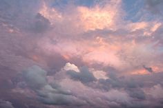 an airplane is flying in the cloudy sky