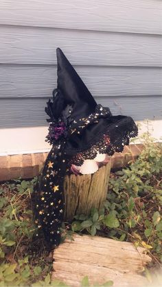 a witches hat sitting on top of a wooden stump