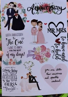 a hand holding up a paper with wedding stickers on it