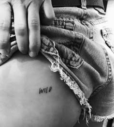 a person holding their stomach with the word wild written on it