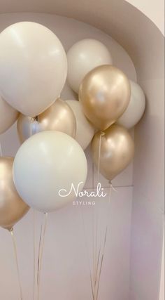 white and gold balloons floating in the air