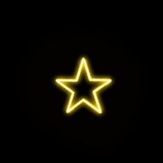 a yellow neon star on a black background with the light reflecting off it's side