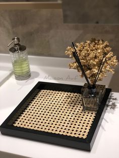 a vase with some flowers in it on a bathroom counter