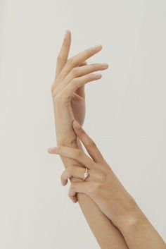 two hands reaching up towards each other