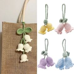 crocheted flowers hang from the handle of a tote bag, and then are attached to strings