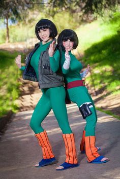 two women dressed in green and orange are posing for the camera while wearing matching outfits