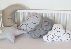 three pillows are sitting on top of a crib