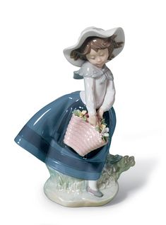 a figurine is sitting on top of a planter with a pink purse