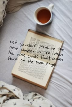 a cup of tea and an open book on a bed with the words, let yourself move in the next corner