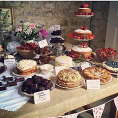 a table topped with lots of cakes and desserts