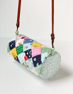 a purse hanging from a hook on a white background