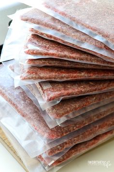 a stack of raw ground meat on top of a cutting board