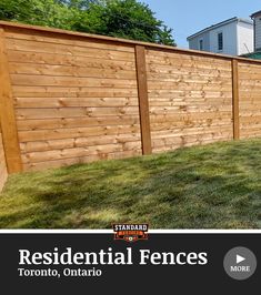 a wooden fence with grass in front of it