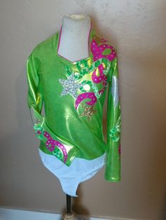 "Such a fun refreshing summer shirt just like our favorite drink! Sweetheart neckline is trimmed in metallic pink. Super Sparkly silver and gold stars and fun swirls adorn the shirt. About 100 high quality AB rhinestones. Comes with attached brief to stay tucked in. Zip back. Merchandise is shipped within 1 to 3 weeks. If needed by a certain date, message us right away, call us at 435.279.6246, or e-mail us at gloria [!at] rodeoqueenshirts.com to check availability. We try to keep 1 of every shi Pink Long Sleeve Festive Tops, Pink Long Sleeve Tops For Festive Occasions, Party Long Sleeve Tops With Glitter Print, Long Sleeve Party Top With Glitter Print, Long Sleeve Glitter Print Party Top, Pink Fitted Top For Festive Occasions, Fitted Pink Top For Festive Occasions, Pink Fitted Tops For Festive Occasions, Fitted Pink Tops For Festive Occasions