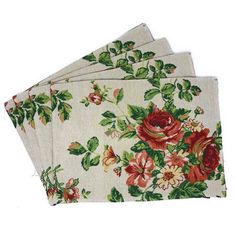 four napkins with red and green flowers on them