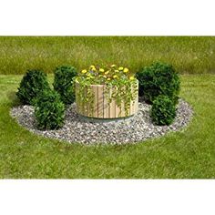 a wooden planter sitting on top of a lush green field