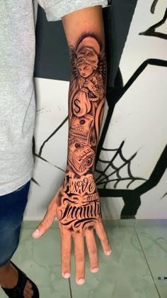 a man with a tattoo on his arm and hand is holding up the word family